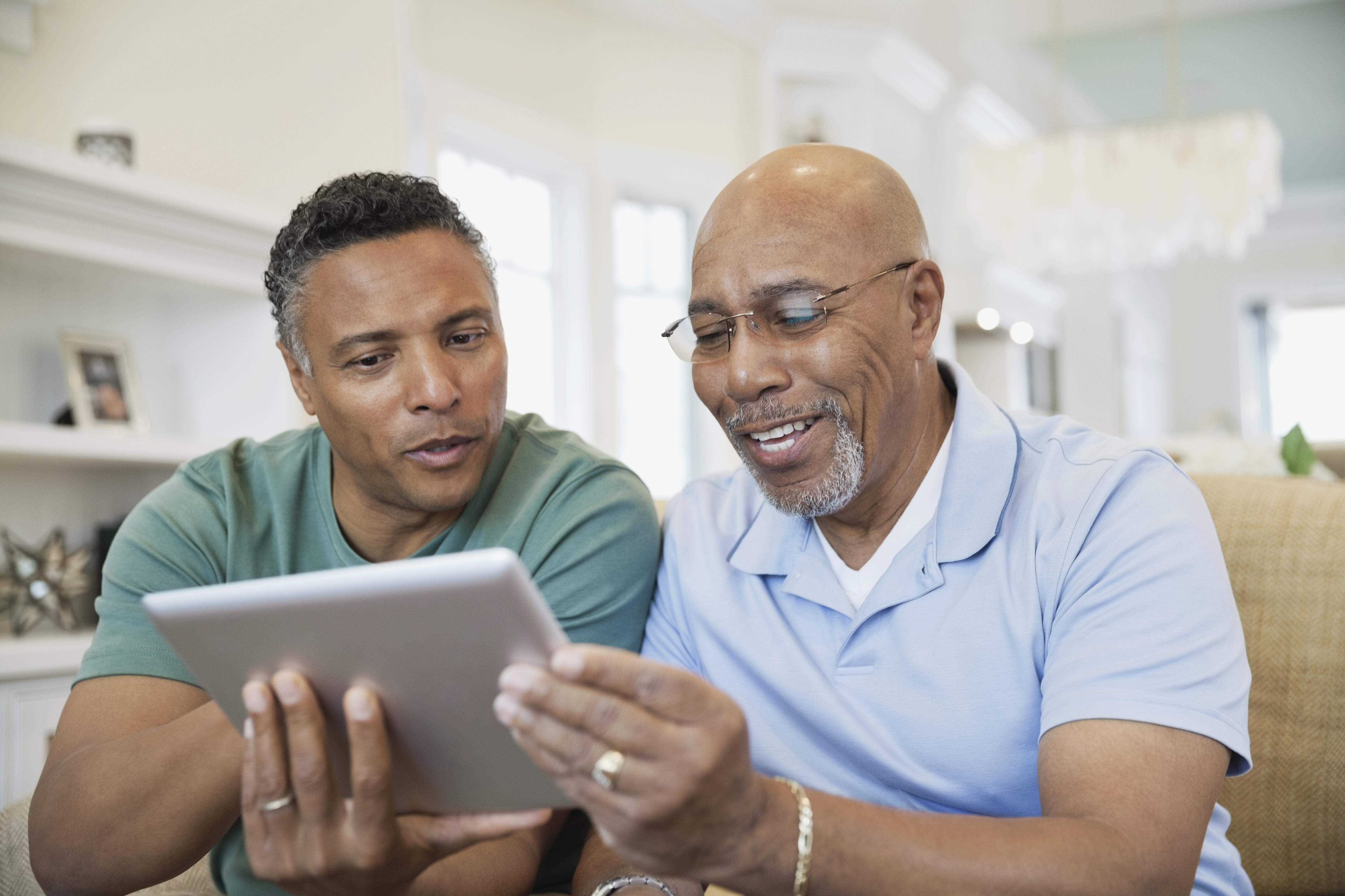 father and son using tablet